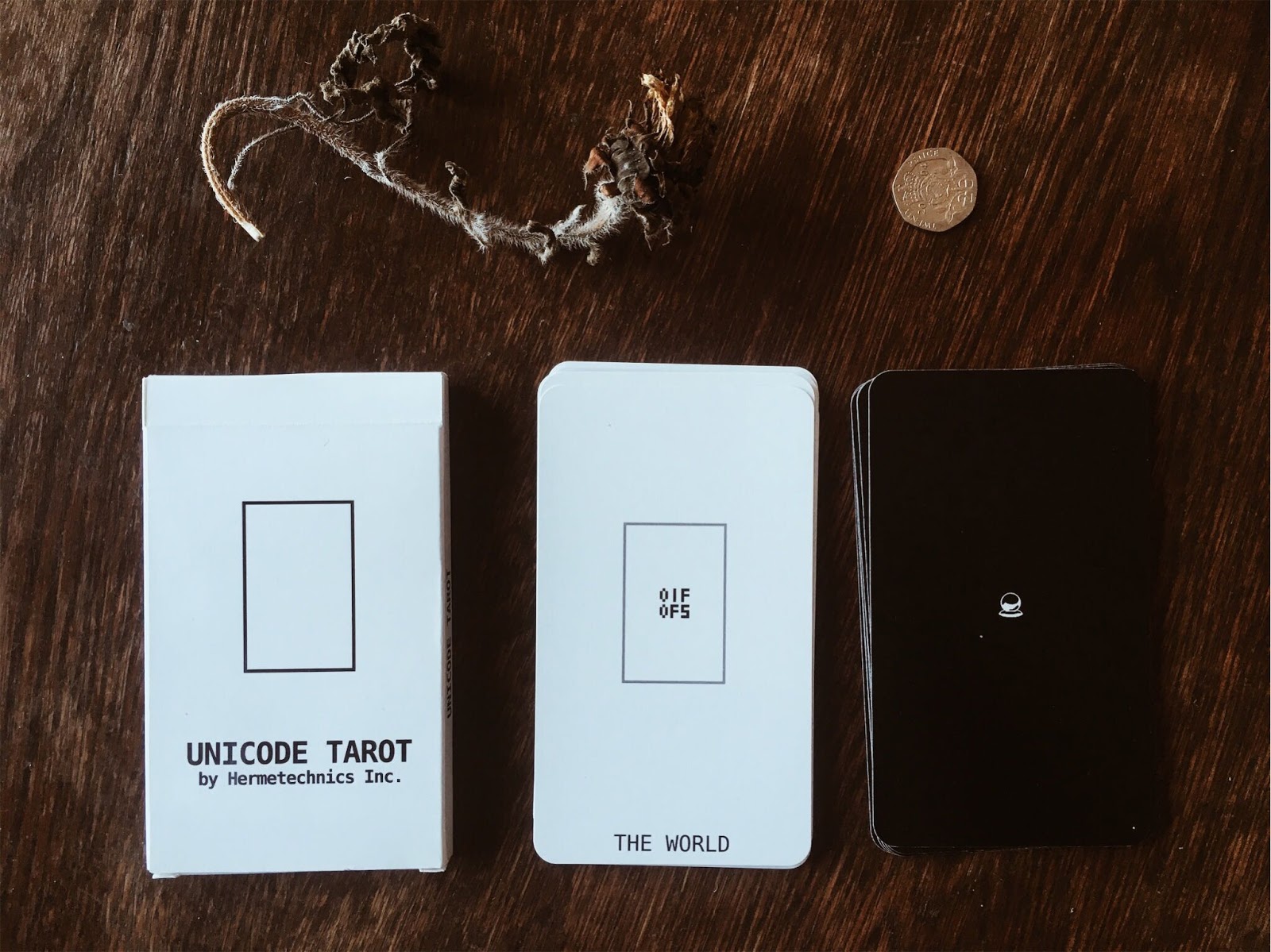 Unicode Tarot deck cards with box facing forward, the World card on top of deck
